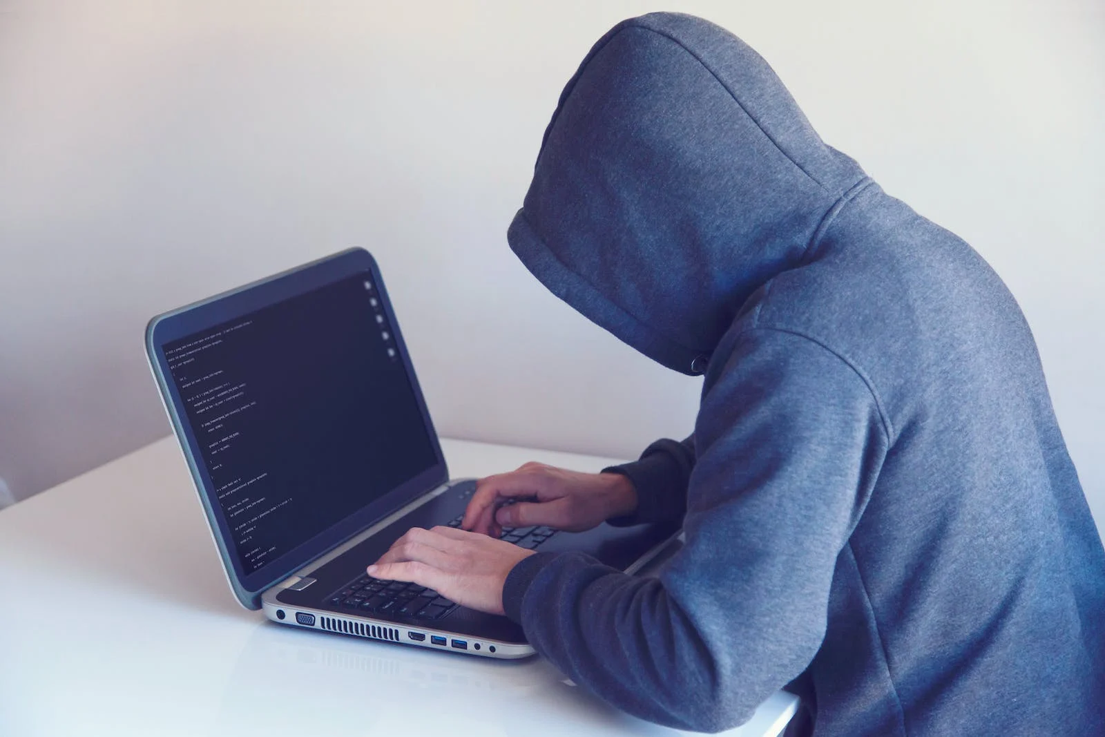 A Person Using A Laptop To Detect Fraud