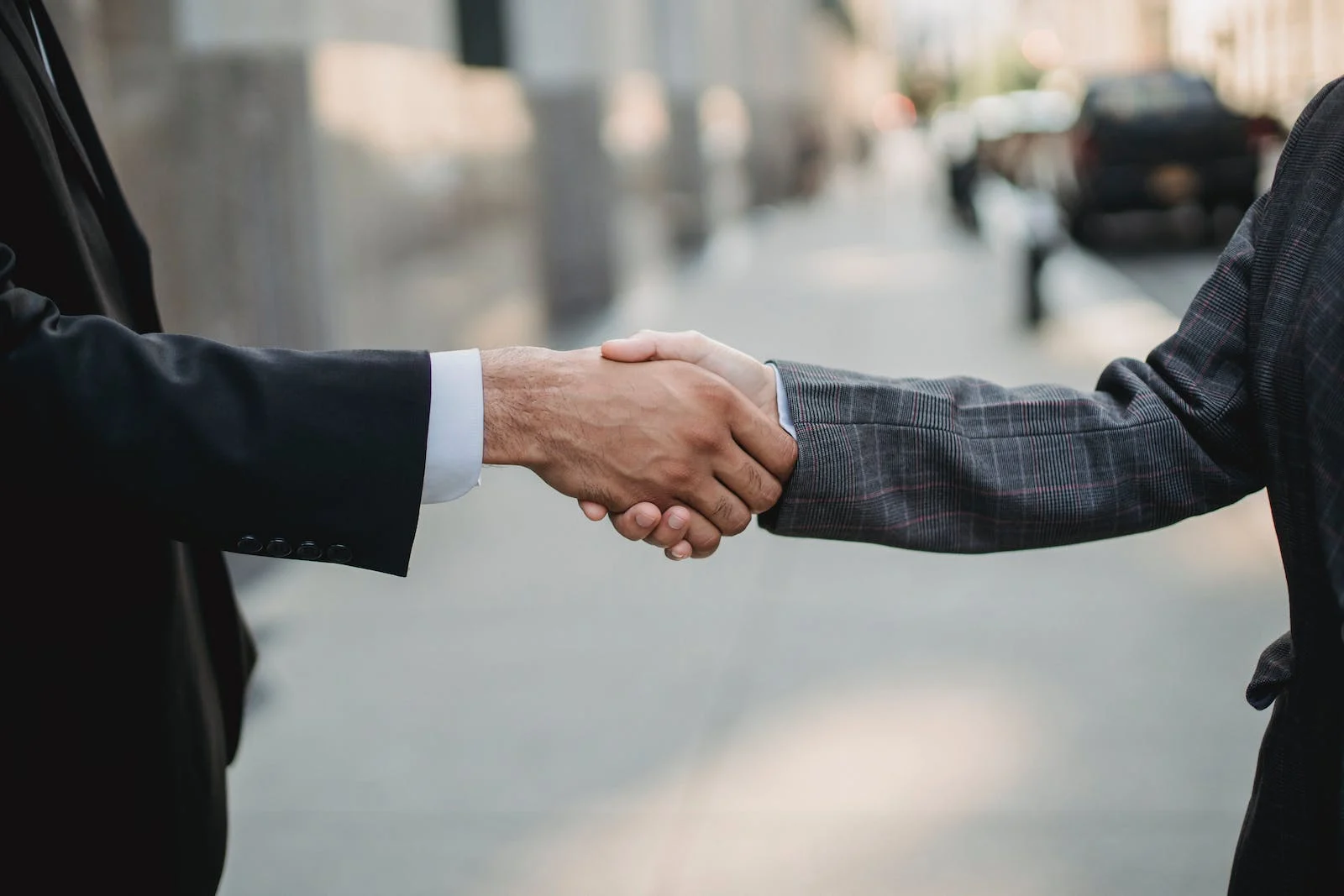 A Person In A Suit Shaking Hands With A Person In A Suit, Symbolizing The Establishment Of An Aml Program