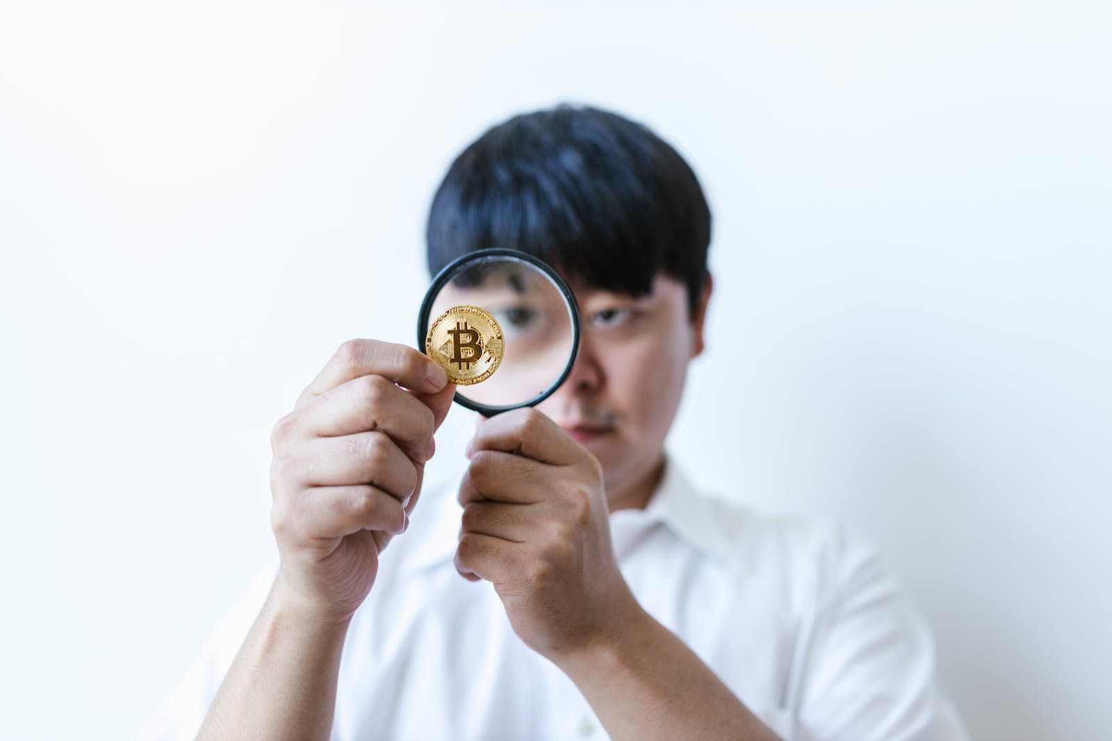 A Person With A Magnifying Glass, Representing The Investigation Of Financial Crimes