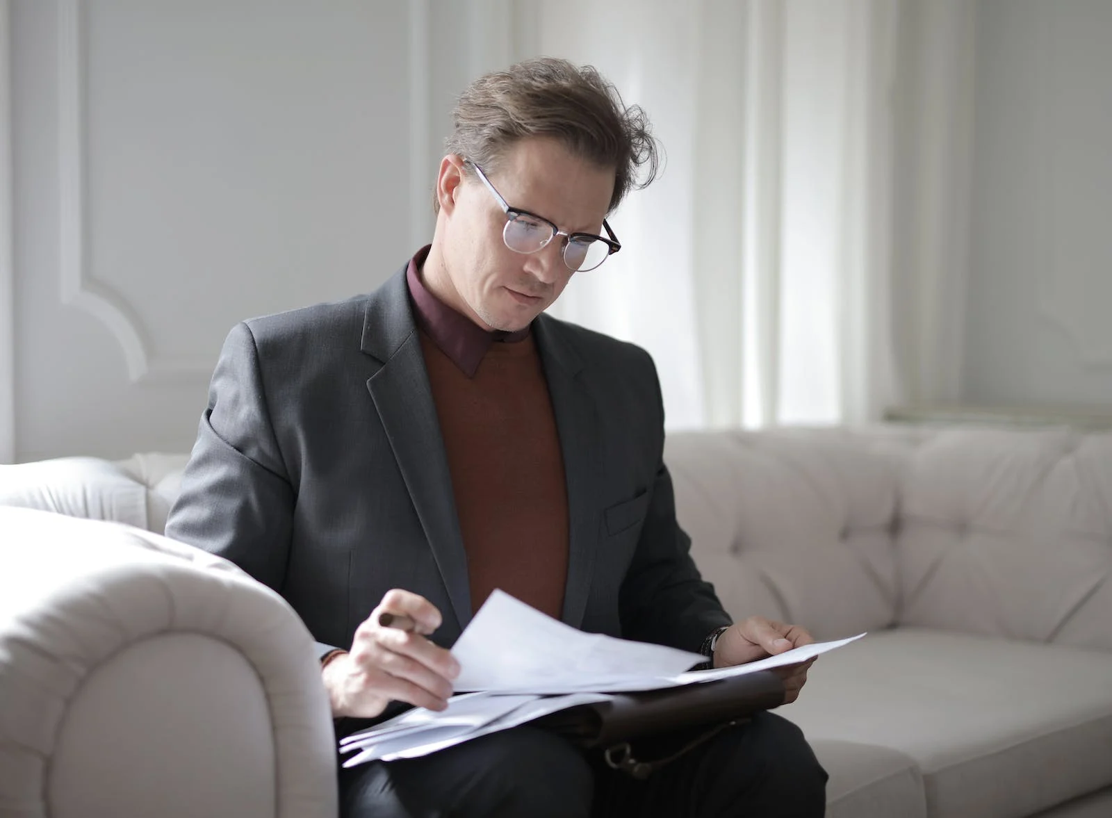 A Person In A Suit Looking At A Document, Symbolizing The Summary And Conclusion Of The Article