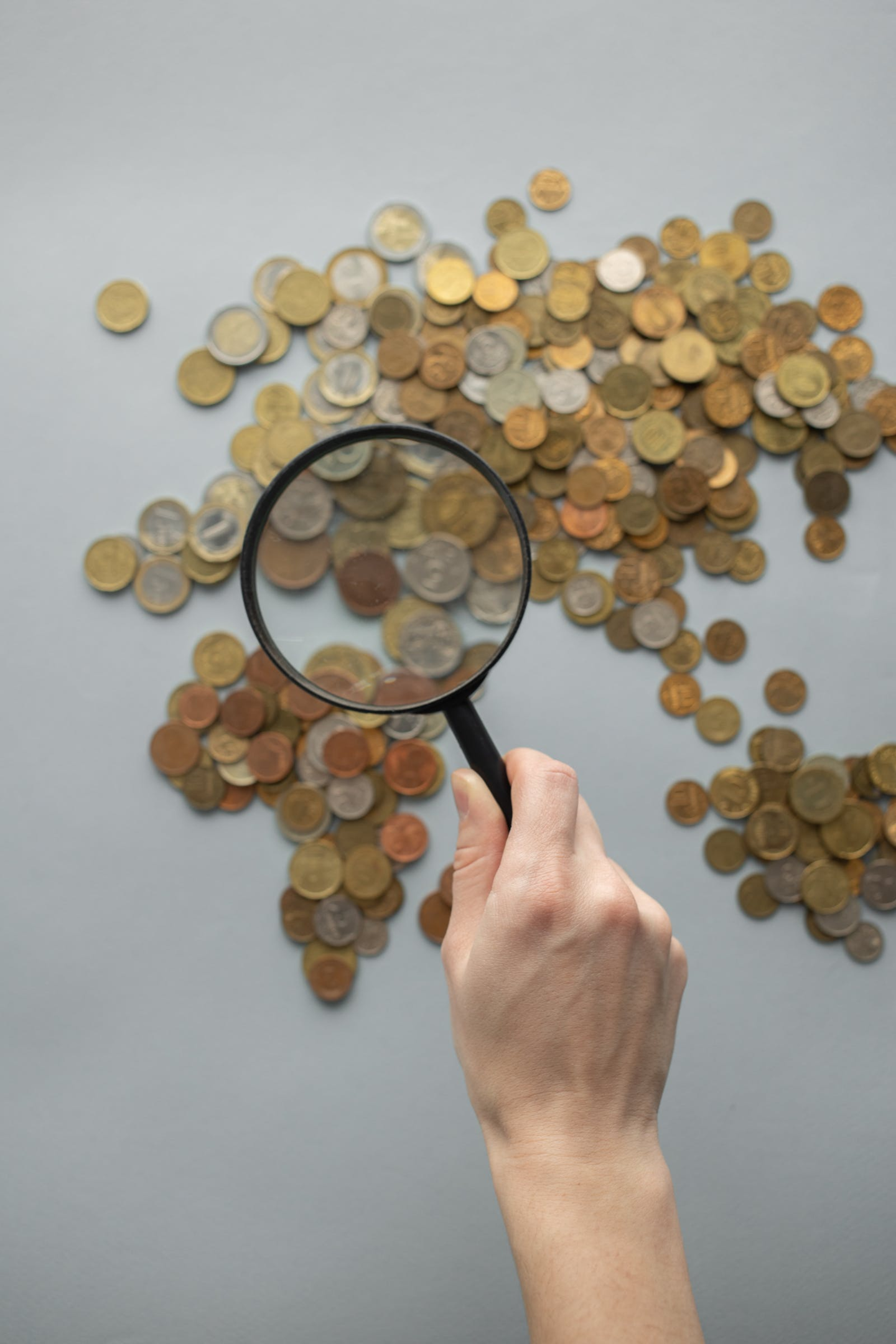 A Person With A Magnifying Glass, Representing Investigation Of Financial Crimes